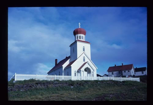 Photo of white church and Priest House.