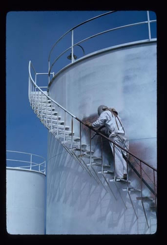 Photo of man working on a water tank.
