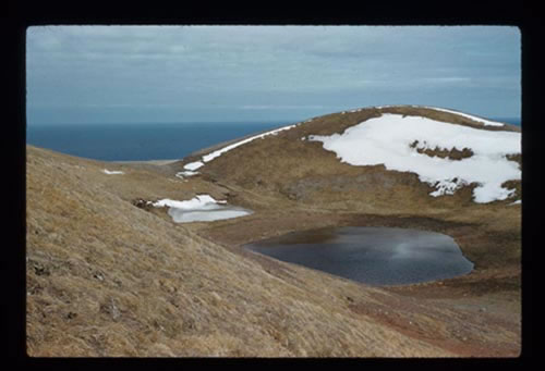 Photo of Polovina crater and lake with residual snow.