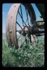 Thumbnail photo of rusted wheel in the tundra grass.