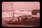 Thumbnail photo of old dock winch and pump houses and surf against the landing.
