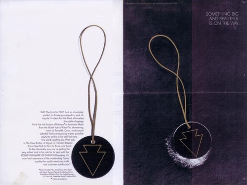 Advertisement illustration of two round pendants with arrow shape inscribed. 