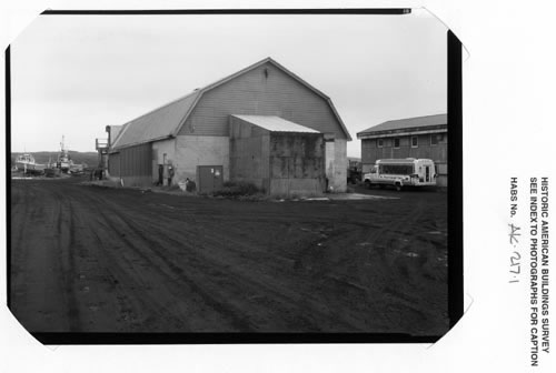Photo of the fish plant, a large barn-style building.