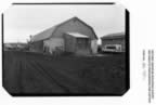 Thumbnail photo of the fish plant, a large barn-style building.