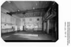 Thumbnail photo of the interior of the machine shop, an open space with a high ceiling.