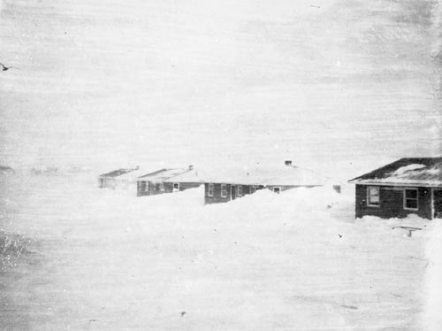 Photo of snowdrifts and houses.