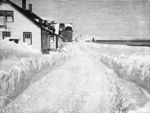 Photo of snowy roads and village; hospital is in foreground on left.