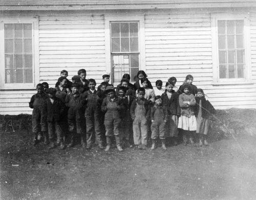 Photo of children outside of building.