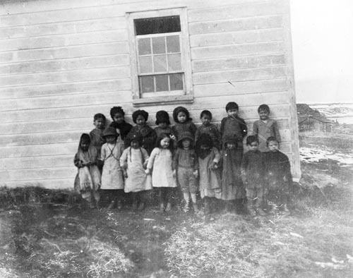 Photo of young children outside of building.