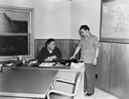 Thumbnail photo of Eaneau and Iliodor Merculieff in the Bureau of Commercial Fisheries Office.