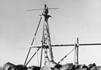 Thumbnail photo of Patrick Kozloff Sr. on tripod used for counting northern fur seal populations.