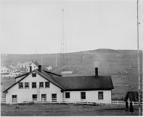 Photo of Company House, with the Naval Radio Complex and cemetery in the background.