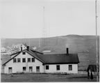 Thumbnail photo of Company House, with the Naval Radio Complex and cemetery in the background.