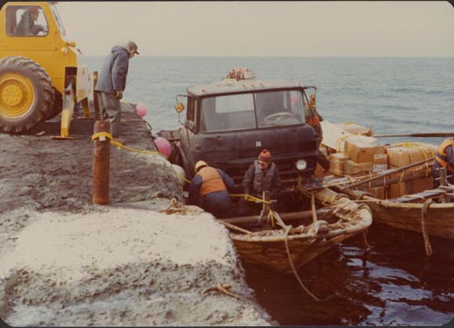 Photo of men loading truck on baidar.