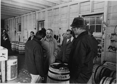 Photo of men inside barreling shed.