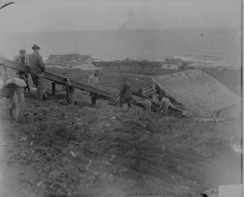 Photo of men setting rail for seal trucks.