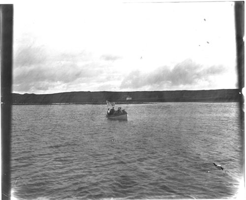 Photo of men in small boat.