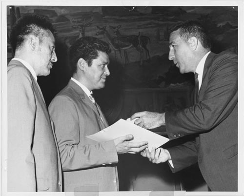Photo of Secretary Udall presenting valor awards to two men.