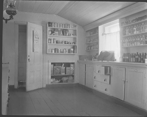 Photo of dispensary with shelves of bottles.