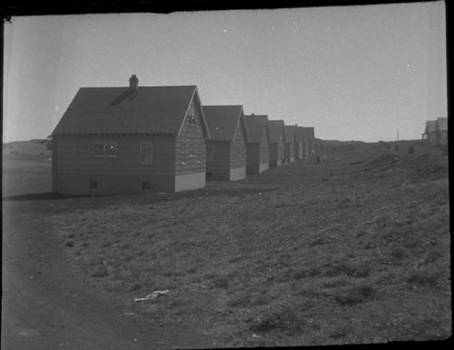 Photo of a row of wooden houses.
