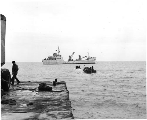 Photo of dock with ship "Penguin II" in the background.