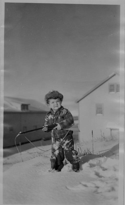 Photo of Boris S. with a toy rifle, age 5.