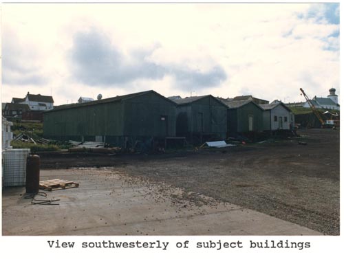 Photo of southwesterly view of four warehouse buildings, lots 12 and 13 of Tract 43.