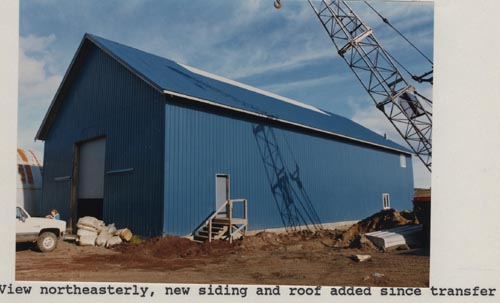 Photo of northeasterly view of the Cascade Building including new siding and roof.