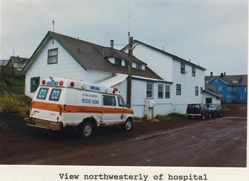Photo of northwesterly view of the hospital with ambulance in front.