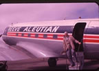 Thumbnail photo of arrival of man descending from ramp of Reeve Aleutian Airplane.