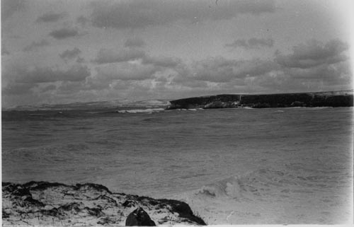Photo of Tolstoi Point from the tank farm showing grouned Ryuyo Maru near far right.