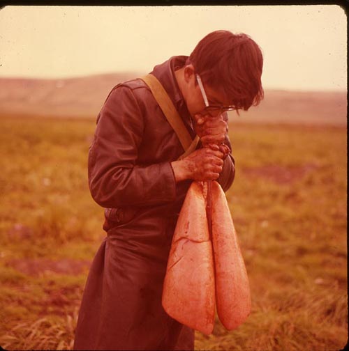 Photo of boy blowing air into seal lung sack.