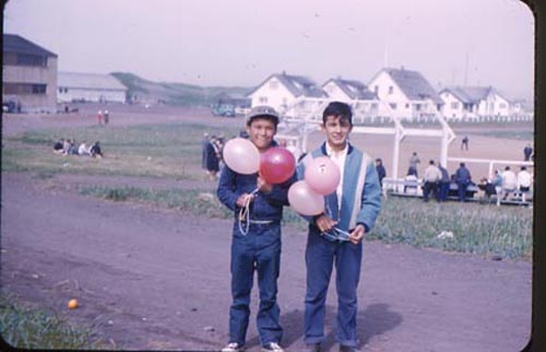 Photo of two boys with balloons.