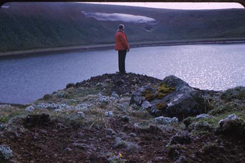 Photo of man standing on edge of Lake Hill.