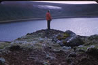 Thumbnail photo of man standing on edge of Lake Hill.