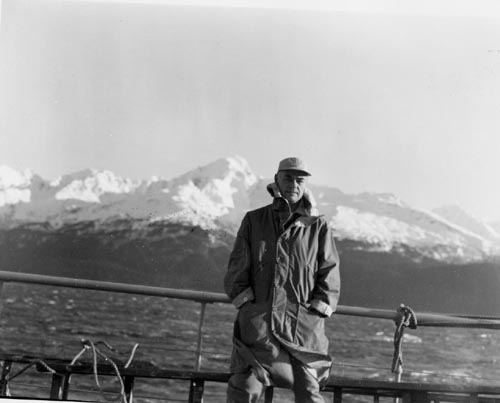 Photo of Victor B. Scheffer leaining on the railing of ship M.S. Black Douglas, fur seal research cruise.