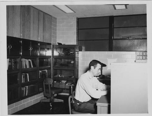 Photo of man sitting at desk in laboratory.