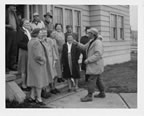 Thumbnail photo of people, priest, and natives in front of Government House.