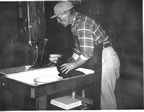 Thumbnail photo of Dr. O. Wilford Olsen standing at a sink.
