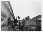 Thumbnail photo of Fouke Fur Co. agent Edward J. Neidel and FWS agent Homer Merriott counting sealskins from killing field to wash house platform