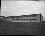 Thumbnail photo of warehouse building, a low two-story structure.