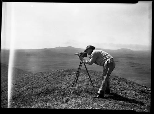 Photo of man with camera on tripod.