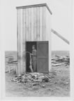 Thumbnail photo of a man with seal carcasses.