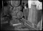 Thumbnail photo of man next to machinery inside the By-Products Plant.