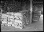 Thumbnail photo of sacks of seal meal inside the By-Products Plant.