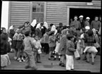 Thumbnail photo of a large group of children and adults at a fourth of July celebration.