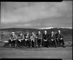 Thumbnail photo of a group of men sitting in a row.