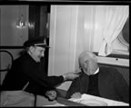 Thumbnail photo of two men on a boat; man on right is Reverend Theodosy of St. George.