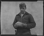 Thumbnail photo of man holding an object.