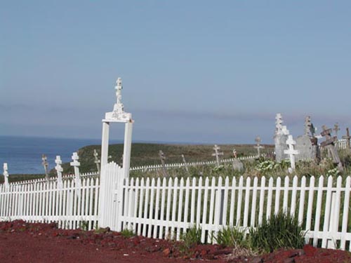 Photo of cemetery with white picket fence.
